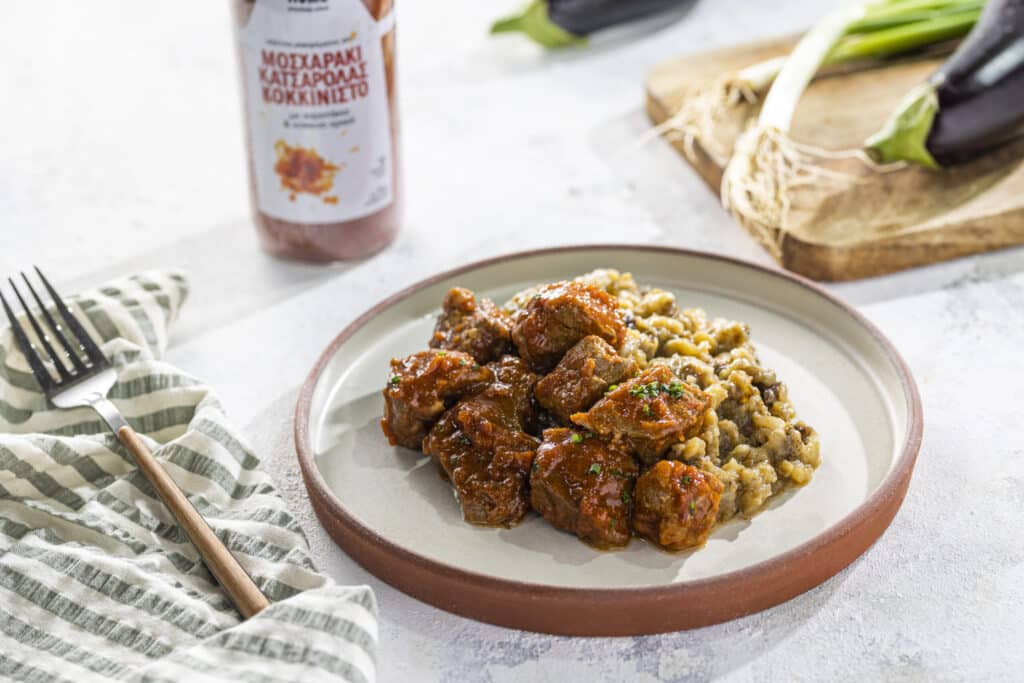 Beef kebab in tomato sauce with eggplant puree